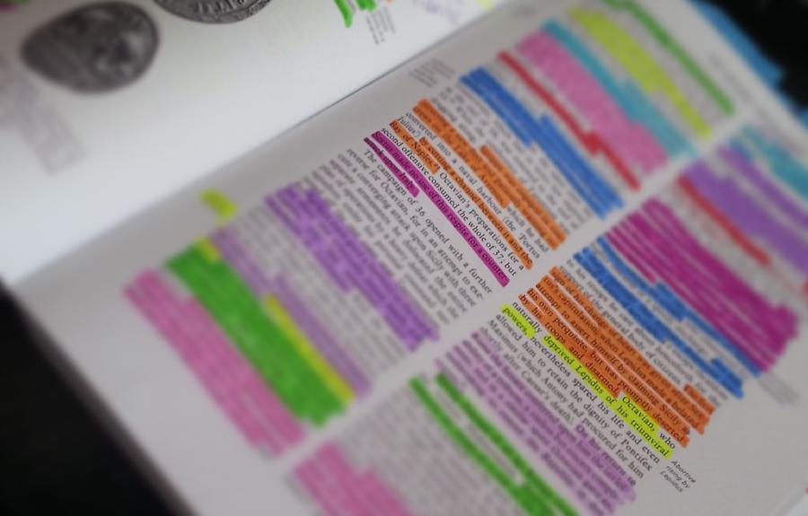 photograph of a book with multicolored highlighted notes